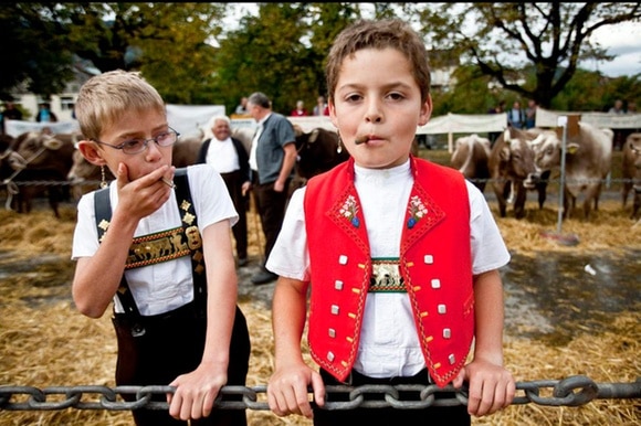 Two boys smoke at a traditional event in Appenzell