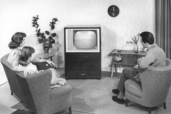 Vintage photo of a family watching TV in the 1960s